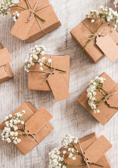 vista-superior-cajas-regalo-boda-flores-aliento-bebe-escritorio-madera_23-2147936662
